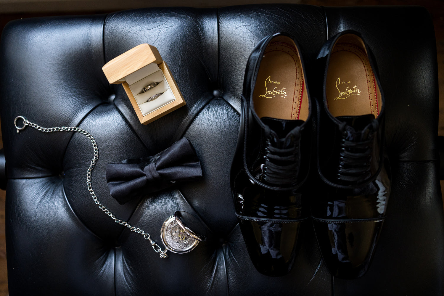 Louboutin shoes with wedding rings, bow tie and round pocket watch